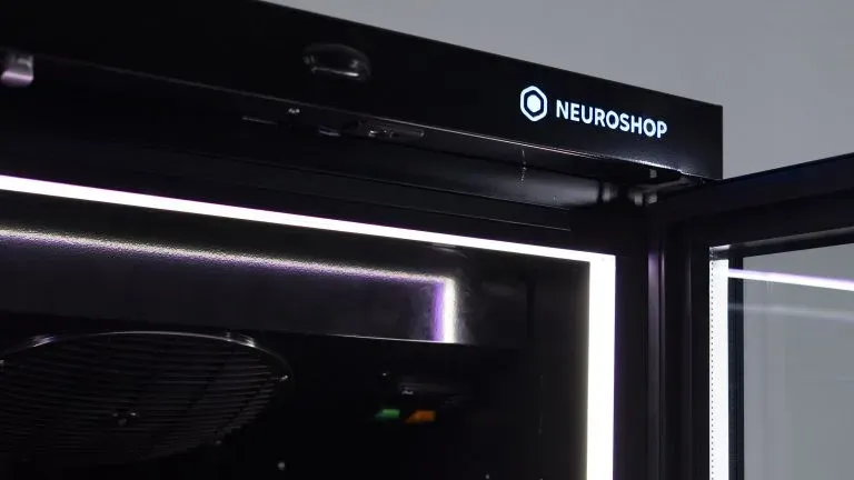 Top panel of a cabinet with a lit Neuroshop logo and an LED strip along the door edge